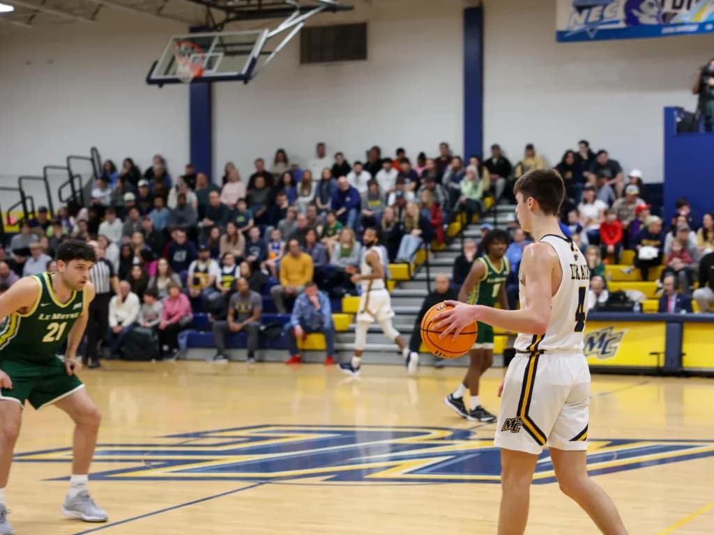 Merrimack basketball player posing during a team event