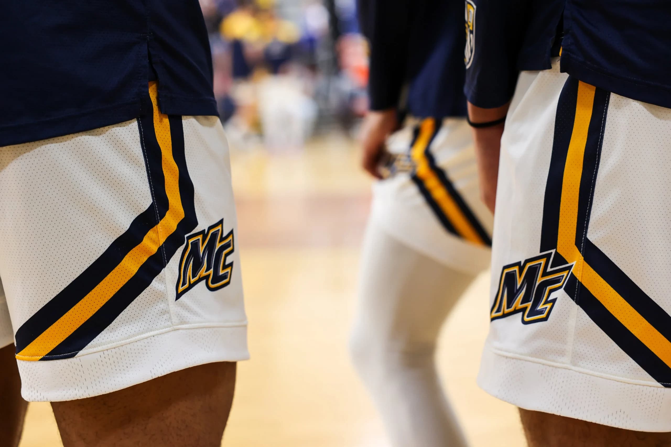 Merrimack basketball players walking onto the court